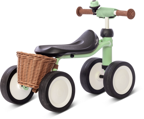 PUKY Babycykel för 1-åringar har en mintfärgad ram, svart sits, fyra svarta och vita hjul, säkerhetshandtag, bruna gummihandtag och en flätad korg för att främja balansen med sin robusta design.