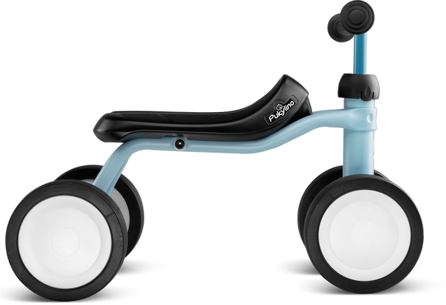 Babycykel - Pukylino - Retro blå från PUKY är designad för små barn för att förbättra sin motorik. Denna ljusblå och svarta balanscykel har en minimalistisk ram, en bekväm sadel och fyra stora vita hjul med släta ytor för stabilitet. Det enkla svarta styret är perfekt för små händer.