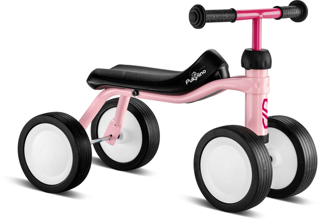 Babycykel - Pukylino - Retro rosé från PUKY är en liten balanscykel med en charmig rosa och svart design med fyra stora vita hjul och en bekväm svart sits. Den är gjord för att små barn ska utveckla sina balans- och koordinationsförmåga, med barnvänlig ergonomi för ökad komfort, medan det rosa styret bidrar med ett lekfullt inslag.