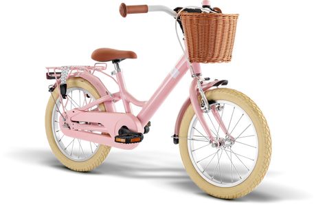 PUKY Barncykel Youke 16 Classic är en snygg rosa cykel för barn från 4 år med lätta funktioner, inklusive en brun flätad korg och bruna däck. Den har brunt styre, en bekväm sadel och ett bakre metallställ, allt med en vanlig vit bakgrund.