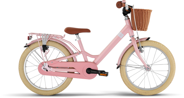 PUKY Youke 18 Classic barncykel är en charmig rosa cykel med beiga däck, en brun sadel och en främre flätad korg. Den har lättviktselement som en bakre bagagehållare med en silverfärgad cykelhållare och svarta pedaler och styrhandtag för kontrast.