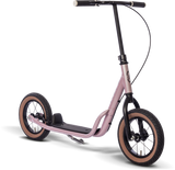 PUKY Sparkcykel - Lufthjul - Pink R 07 L har en rosa sparkcykel med ett svart styre, stora svarta hjul med bruna fälgar, en elegant metallram och ett däck med matt finish, allt slående mot en vit bakgrund.